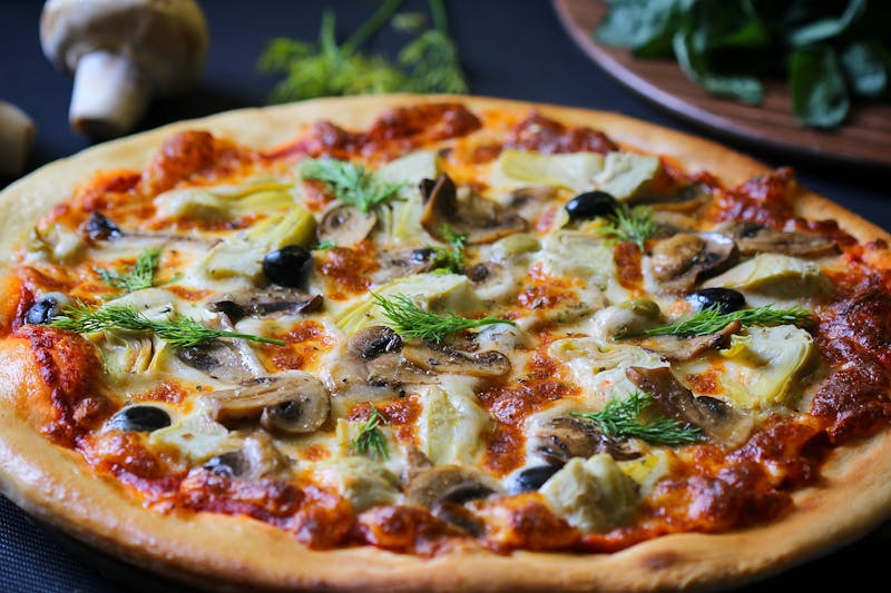 White Truffle pizza with mushrooms and arugula