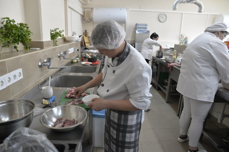 Via 313 team member preparing pizza dough by hand